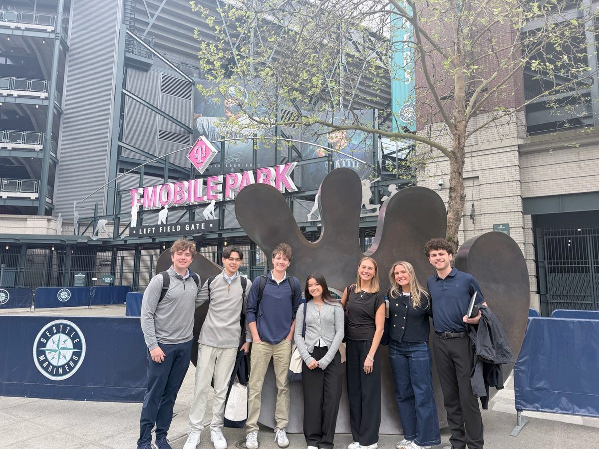 Eight students outside the left field gate at T-Mobile Park.